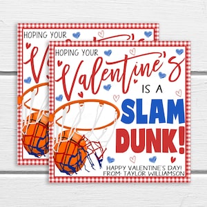 May include: Two red and white gingham patterned Valentine's Day cards with a basketball hoop and basketball. The text on the card reads "Hoping your Valentine's is a Slam Dunk! Happy Valentine's Day! From Taylor Williamson."