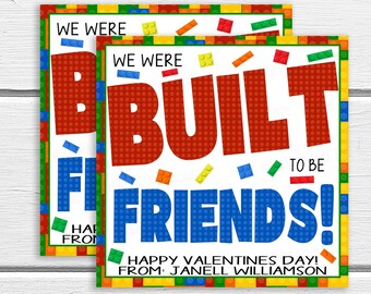 May include: A Valentine's Day card with a Lego theme. The card is red, blue, yellow, and green. It says "We were built to be friends!" and "Happy Valentine's Day! From: Janell Williamson".