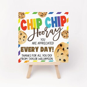 May include: A white card with a rainbow striped border and a message that says "Chip Chip Hooray You Are Appreciated Every Day! Thanks for all you do! From Taylor Williamson". The card is decorated with chocolate chip cookies.