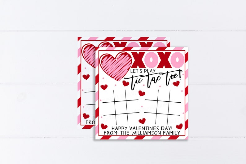 May include: Two red and pink Valentine's Day tic-tac-toe game cards with hearts and the text "XOXO Let's Play Tic Tac Toe! Happy Valentine's Day! From the Williamson Family"