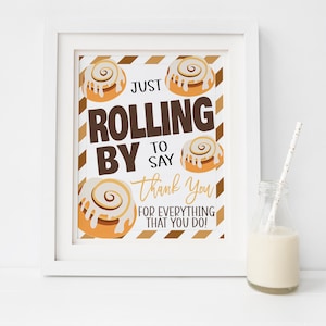 May include: A printable sign with a brown and gold striped background. The sign features a graphic of cinnamon rolls and the text "Just Rolling By To Say Thank You For Everything That You Do!"