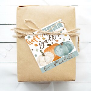 May include: A gift tag with a watercolor illustration of pumpkins and fall leaves. The text on the tag reads "Happy Fall y'all!" and "love, Michelle".