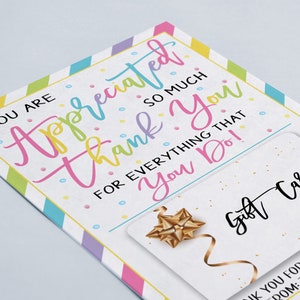 May include: A white card with a colorful striped border and confetti. The card says "You are appreciated so much thank you for everything that you do!" and has a space for a gift card. The gift card is white with a gold bow and the words "Gift Card" written in black.