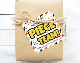 May include: A brown gift box with a yellow, orange and black gift tag that reads "You are an important piece of our team! From: The Sunshine Beach PTO".