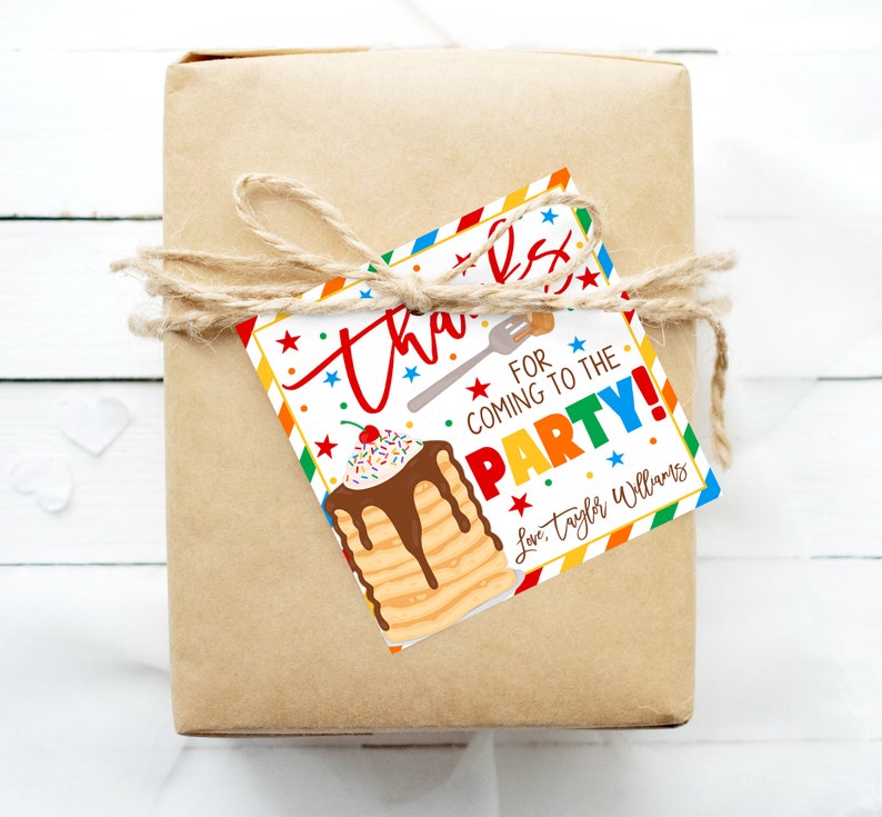 May include: A wrapped gift in brown paper tied with twine, featuring a colorful tag. The tag reads "Thanks for coming to the party!" with a pancake illustration and the name "Taylor Williams."