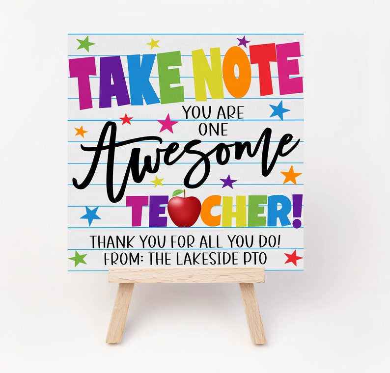 May include: A colorful sign with the text "TAKE NOTE YOU ARE ONE AWESOME TEACHER!" with a red apple and stars. The sign is on a small wooden easel. The text "THANK YOU FOR ALL YOU DO! FROM: THE LAKESIDE PTO" is at the bottom of the sign.