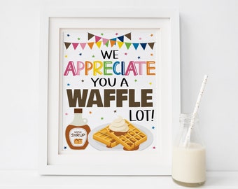 May include: A white framed print with the text "We appreciate you a waffle lot!" in colorful letters. The print features a cartoon illustration of waffles with whipped cream and syrup.