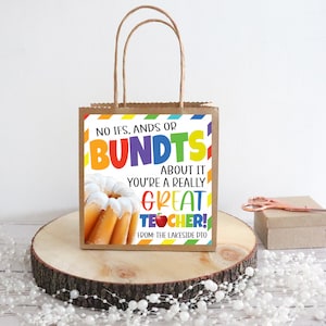 May include: A brown paper gift bag with a colorful printed tag that says "No ifs, ands or bundts about it you're a really great teacher!" with a picture of a bundt cake. The tag also says "From: The Lakeside PTO".