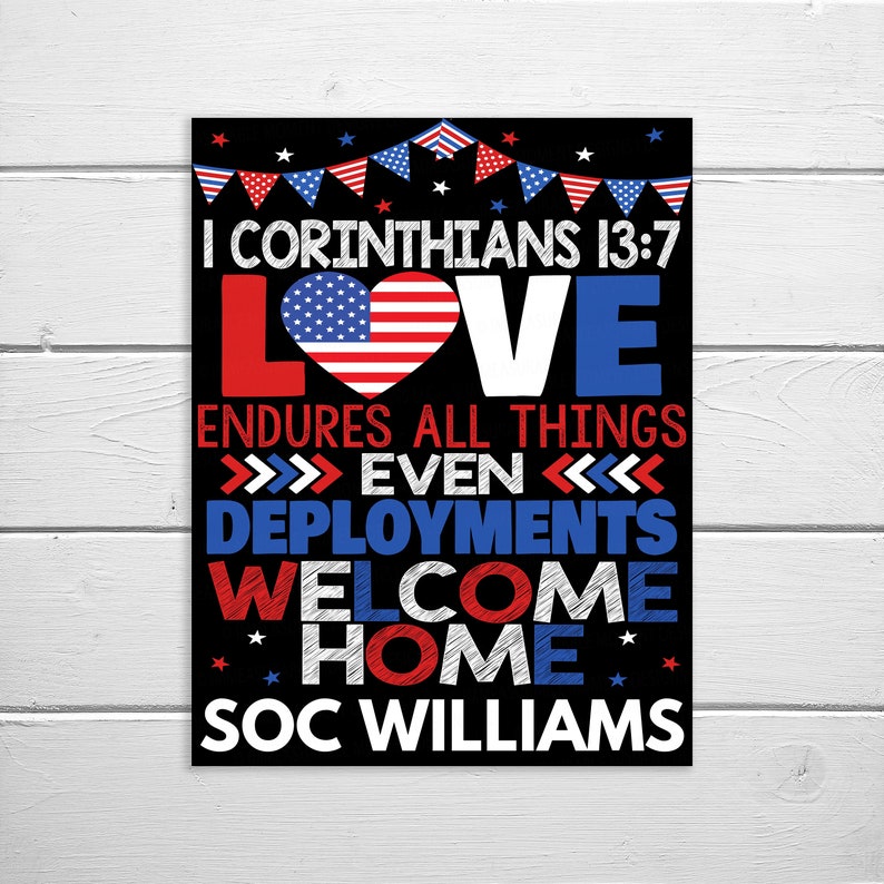 May include: A black and white sign with red, white, and blue accents. The sign features the text "I Corinthians 13:7 LOVE ENDURES ALL THINGS >>>>> EVEN <<<<<< DEPLOYMENTS WELCOME HOME SOC WILLIAMS". The text is in a handwritten style and the word "LOVE" is in a large font with an American flag heart in the middle.