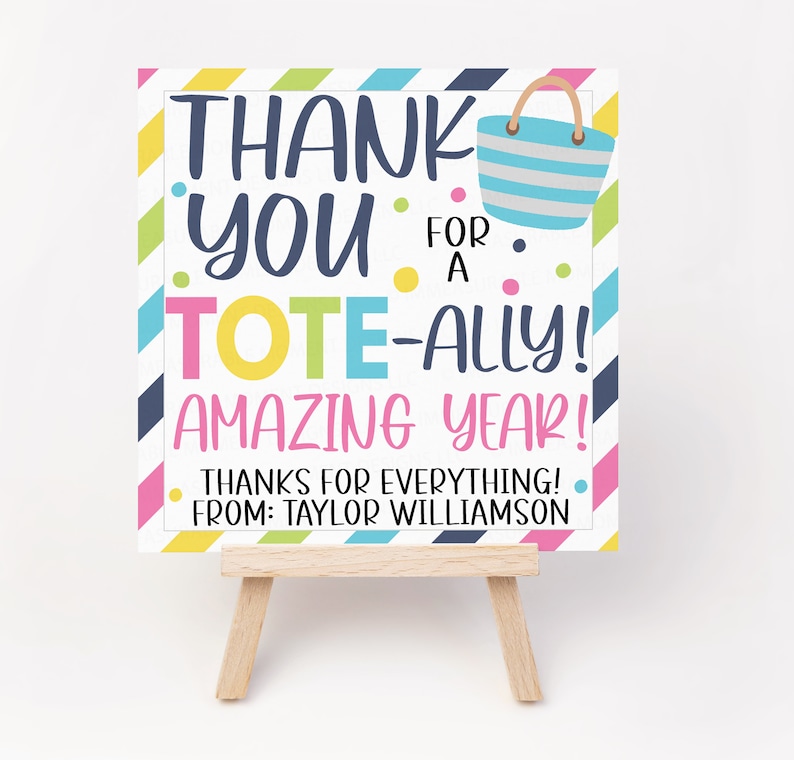May include: A colourful thank you card with a striped tote bag design. The card says "Thank You for a Tote-ally Amazing Year! Thanks for everything! From: Taylor Williamson."
