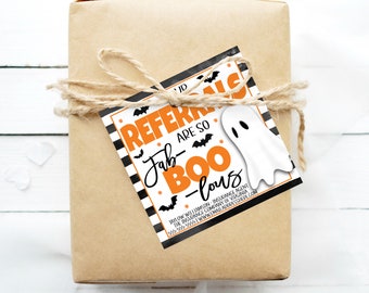 May include: A brown gift box with a black and white striped tag that says "Referrals are so Fab-Boo-lous". The tag has a white ghost and orange bats on it.