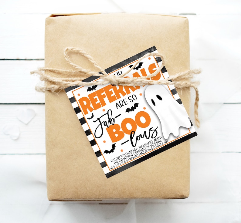 May include: A brown gift box with a black and white striped tag that says "Referrals are so Fab-Boo-lous". The tag has a white ghost and orange bats on it.