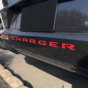 May include: A set of three ceramic mugs with a speckled, matte finish. The mugs are in shades of cream, light grey, and dark grey. Each mug has a simple, minimalist design and a rounded handle. Ideal for tea or coffee.