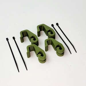 May include: Five olive green plastic clips and three black zip ties. The clips have a hook shape and are designed to hold items together.