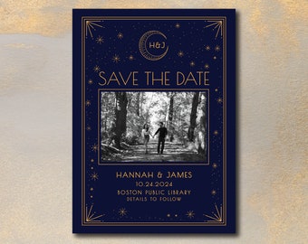 May include: A navy blue save the date card with gold accents and a crescent moon design. The card features a black and white photo of a couple walking in a forest. The text reads "H&J Save the Date Hannah & James 10.24.2024 Boston Public Library Details to Follow."