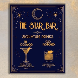 May include: A blue and gold sign with the text "The Star Bar" and "Signature Drinks". The sign features illustrations of two cocktails: "The Cosmos" and "Old Fashioned".