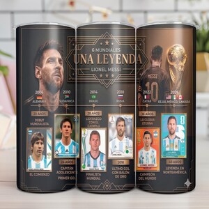 May include: A cylindrical tumbler featuring a graphic design of Lionel Messi, including his portrait, the text 6 MUNDIALES UNA LEYENDA, and a timeline of his career from 2006 to 2026 with various photographs, country flags, and descriptive text labels.