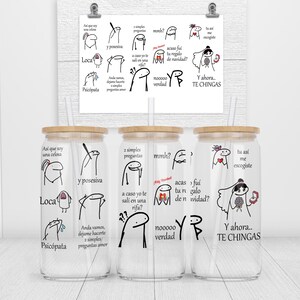 May include: Three clear glass tumblers with bamboo lids and straws. Each tumbler features a black and white cartoon illustration with Spanish text. The text on the tumblers reads "Asi que soy una celosa", "2 simples preguntas", and "Tu asi me escogiste".