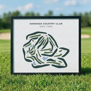 May include: Framed print of the Gowanda Country Club golf course in New York. The course layout is depicted in green and blue on a white background, with the club name and location at the top. The frame is black.