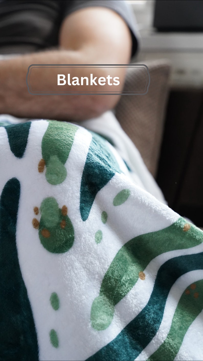 a person laying down on a couch with a blanket