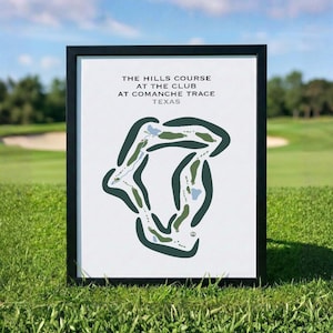 May include: A framed print featuring a stylized golf course map titled THE HILLS COURSE AT THE CLUB AT COMANCHE TRACE TEXAS. The graphic displays dark green fairways, light green greens, and light blue water hazards on a white background.