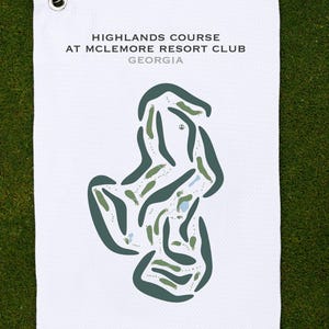May include: White golf towel featuring a course map of the Highlands Course at McLemore Resort Club, Georgia. The map is in green and blue hues, showing the course layout. The towel has a metal grommet and hook.