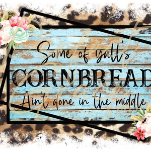 May include: A blue wooden sign with the text "Some of y'all's cornbread ain't done in the middle" on a leopard print background with floral accents.