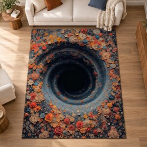 May include: A rectangular area rug featuring a dark blue and black central spiral vortex design. The edges of the rug are decorated with a dense pattern of multi-colored floral shapes in shades of orange, red, beige, and blue, creating a 3D effect.