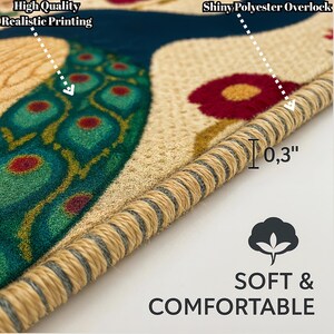 May include: Close-up of a colorful rug with a peacock design. The rug has a beige background with green, blue, and red accents. The edges of the rug are finished with a beige overlock stitch. The text "Shiny Polyester Overlock" is visible in the top right corner of the image. The text "High Quality Realistic Printing" is visible in the top left corner of the image. The text "Soft & Comfortable" is visible in the bottom right corner of the image.
