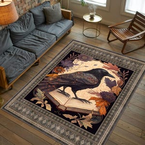 May include: A black raven with intricate details sits on an open book with a floral design. The book is surrounded by leaves and flowers. The rug has a dark background with a decorative border.