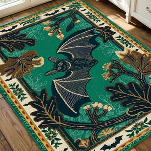 May include: A green and brown rug with a black bat design. The bat is surrounded by leaves and flowers. The rug has a white border with a yellow and red pattern.