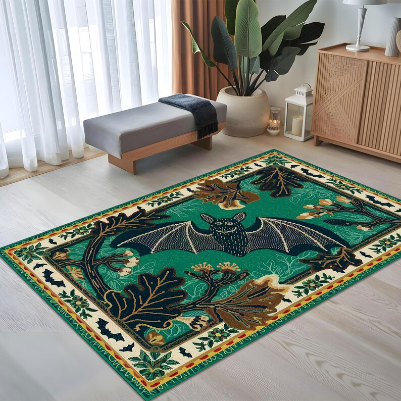 May include: A green and cream area rug with a black bat design. The bat is surrounded by leaves and flowers. The rug has a yellow and red border.