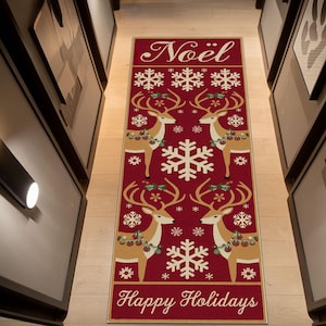 May include: A rectangular red Christmas runner rug featuring reindeer, snowflakes, and the words "Noël" and "Happy Holidays" in white script. The reindeer have antlers and are adorned with festive decorations.
