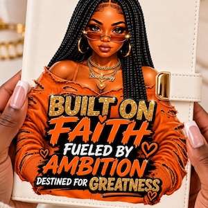 May include: A white notebook featuring a graphic of a person with long black braided hair wearing an orange distressed sweater and gold jewelry. The text reads: BUILT ON FAITH, FUELED BY AMBITION, DESTINED FOR GREATNESS, and Boss Energy.