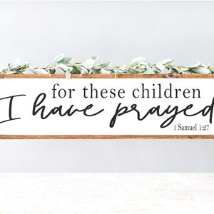 May include: A wooden sign with the text "for these children I have prayed" and the scripture reference "1 Samuel 1:27".