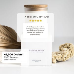 May include: A white Wisdom House coconut wax candle with a wooden lid. The packaging includes text that reads "Wonderful Reviews!" and "45,000 Orders! 8500 Reviews 5 STAR AVERAGE". The candle is 230g/8oz.