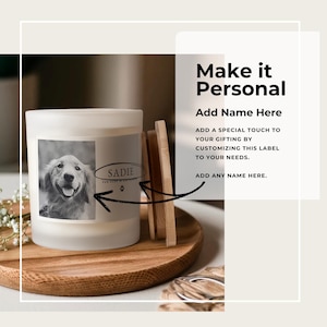 May include: A white candle with a black and white photo of a dog on the label. The candle is on a wooden tray with a wooden lid. Text on the label says "SADIE" and "FUR EVER IN OUR HEARTS". The text "Make it Personal" is also visible.
