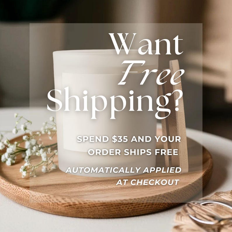 May include: A frosted glass candle in a wooden tray with the text "Want Free Shipping?" and details about free shipping on orders over $35. The candle is white, and the tray is light brown.