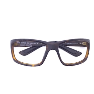 May include: Tortoiseshell-patterned eyeglasses with a rectangular frame shape. The inner temple arms feature white printed text including 'MAUI MJ0766B 003 61-16-130 M' and 'Made in Mauritius'. The nose bridge is curved and the temples are black.