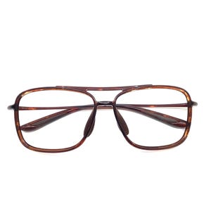 May include: Brown aviator-style eyeglasses with a double bridge and rectangular lenses. The frames have a tortoiseshell pattern, and the lenses are clear. The glasses are set against a white background.