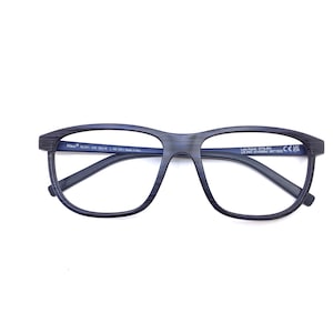 May include: Dark blue eyeglasses with a rectangular frame. The glasses have a textured appearance and a subtle gradient. The arms and bridge are a matching dark blue. The brand name "Maui" is visible on the frame.