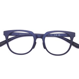 May include: Navy blue eyeglasses with a rounded frame and dark temples. The glasses have a modern design and are set against a white background. The frame has a matte finish.