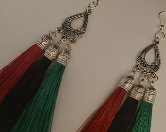 Unique style earring with three tassels.  Red, black, and green