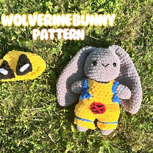 May include: A handmade gray bunny plushie wearing a yellow and blue outfit with a red emblem, and a matching yellow mask with black eye details. The text "WOLVERINE BUNNY PATTERN" is at the top.
