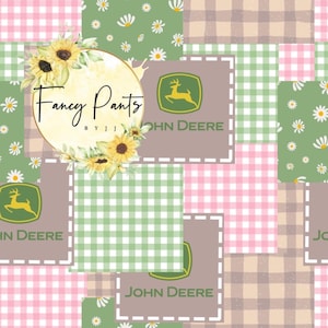 May include: A patchwork design featuring squares of pink gingham, green gingham, and tan plaid. The design includes the John Deere logo and the text "Fancy Pants" surrounded by sunflowers and daisies.