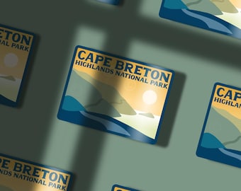 May include: A blue and yellow sticker with the text "Cape Breton Highlands National Park" and a stylized image of a mountain range and a body of water.