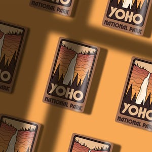 May include: A set of six brown and white stickers with a retro design featuring a waterfall and the text "Yoho National Park".