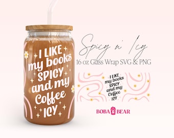 May include: A clear glass tumbler with a wooden lid and a curved glass straw. The tumbler is filled with a brown liquid and features the text "I like my books SPICY and my Coffee ICY". The design includes floral and star accents.