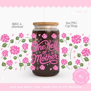 May include: A clear glass can-shaped cup with a wooden lid and a straw. The cup features the text "One hell of a Mother" in pink script. Pink floral and heart designs surround the cup. The cup is 9.45" x 4" and holds 16oz.