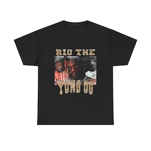 Könnte beinhalten: Schwarzes T-Shirt mit einem Foto von drei Männern und dem Text "RIO THE YUNG OG" in goldenen Glitzerbuchstaben.